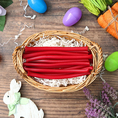 Red Vines Red Ropes licorice in an Easter basket  surrounded by confetti and plastic eggs