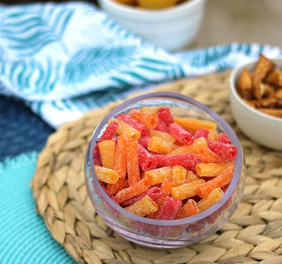 Sour Punch Bites Tropical Flavors in a bowl near other poolside snacks