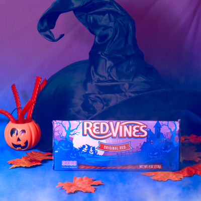 RED VINES Halloween Candy 4oz Tray in a spooky scene with a witch hat, leaves, and mini pumpkin 