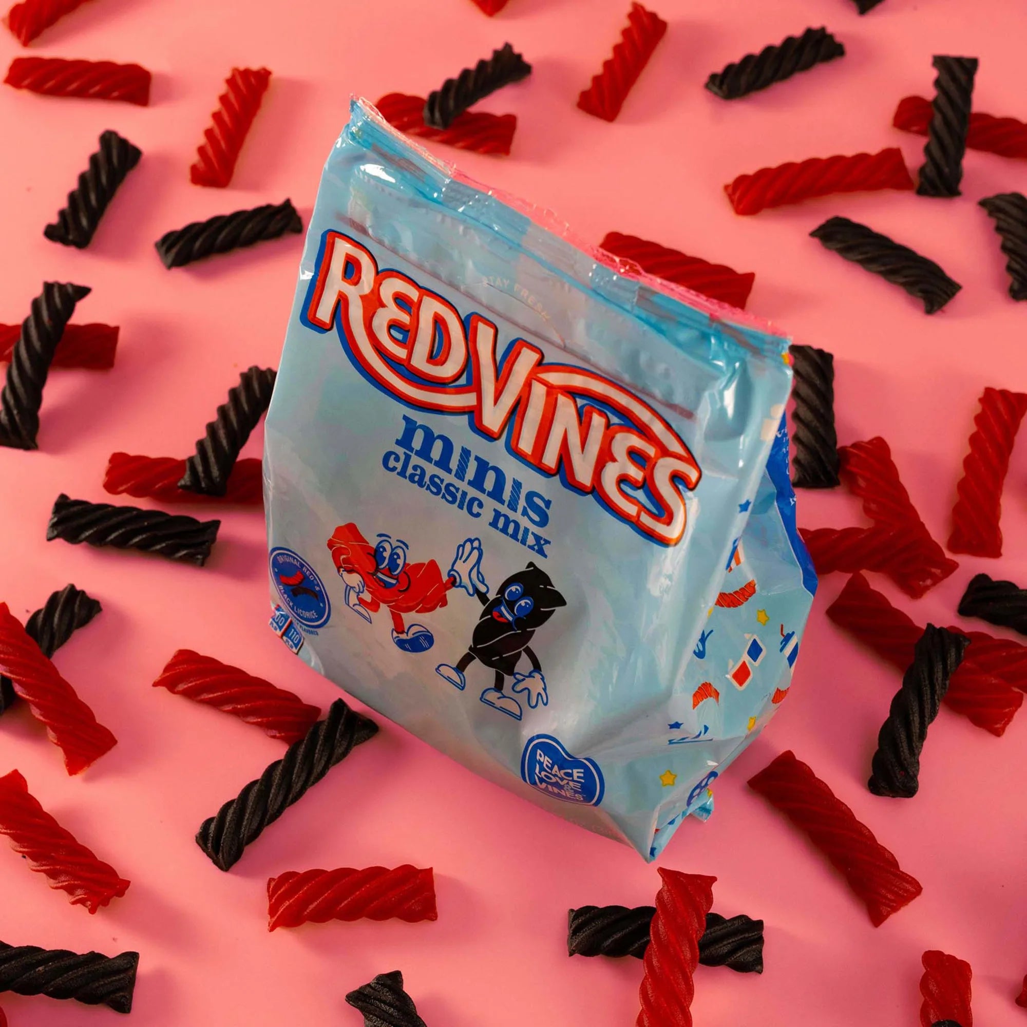Red Vines Classic Mix Minis Bag surrounded by mini red and black licorice