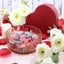 SOUR PUNCH Sweet Bites Candy in a glass dish surrounded by white roses and red sparkle hearts