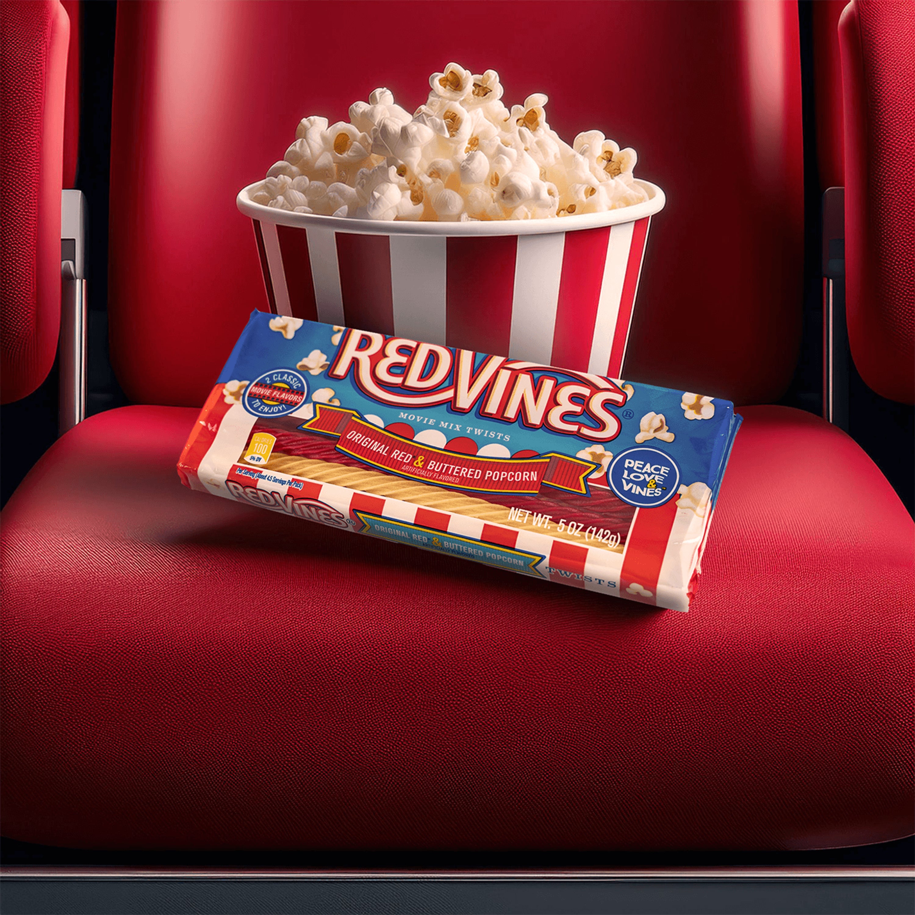 Red Vines Buttered Popcorn & Original Red Twists with fresh popcorn on a movie theater seat