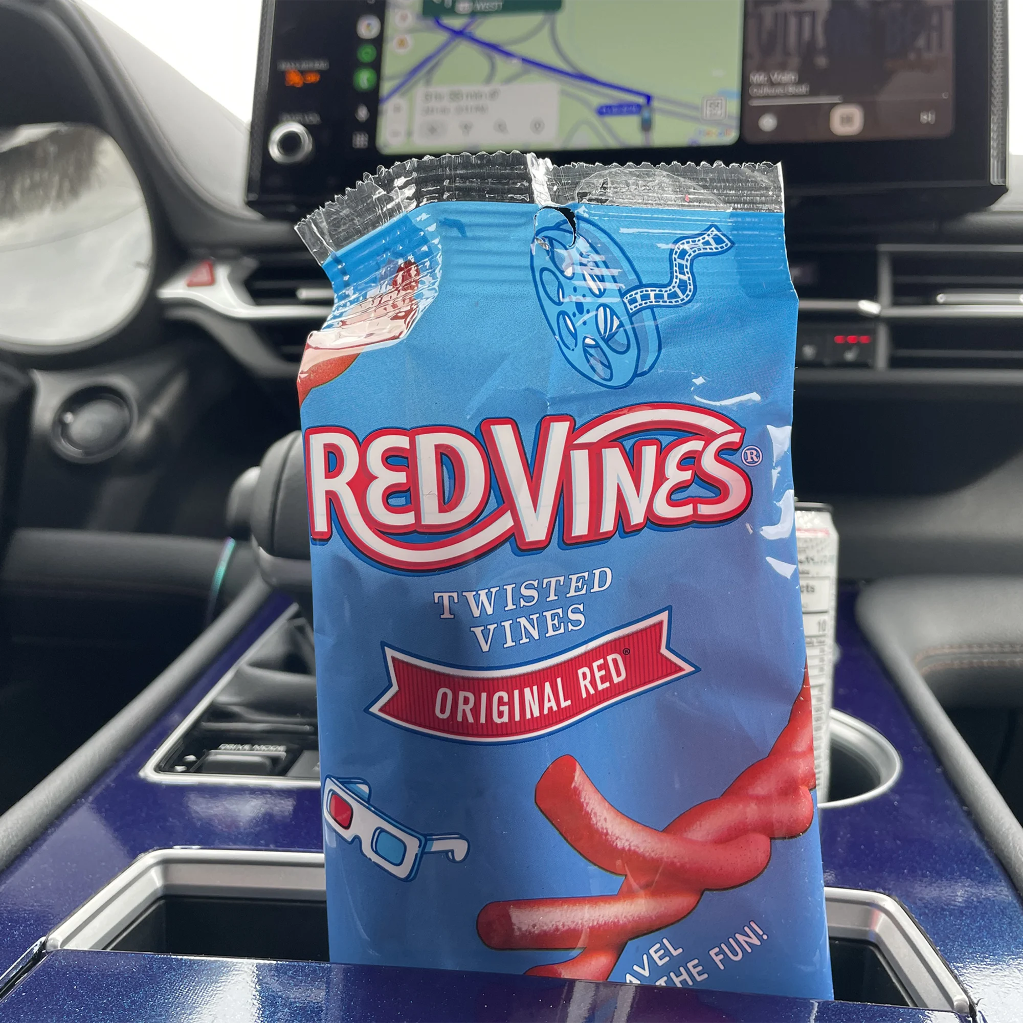 Red Vines Original Red Twisted Vines Candy 4oz Bag in a car cup holder