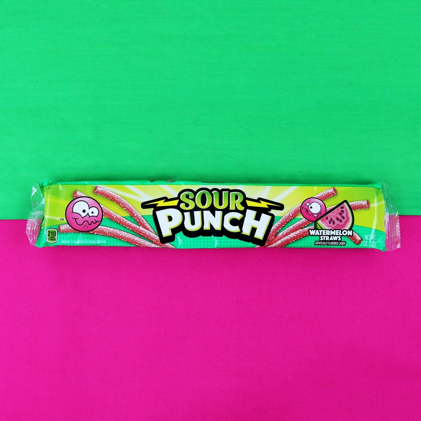 Sour Punch Watermelon Candy Straws 2oz Tray on a fuchsia and green background