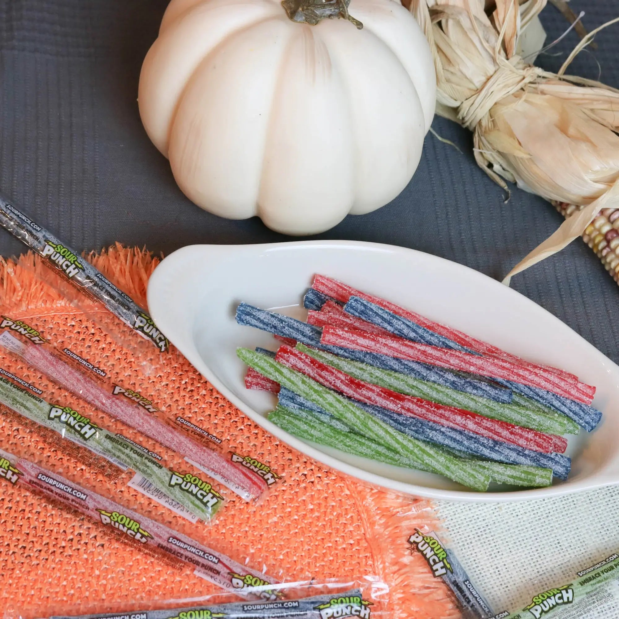Sour Punch Individually Wrapped 6in Twists Assorted Candy in a white dish near a pumpkin and falltime props