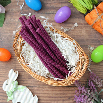 Red Vines Grape Twists licorice candy in an Easter basket  surrounded by confetti and plastic eggs