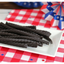 Red Vines Black Licorice Candy Twists on a picnic table with patriotic decorations