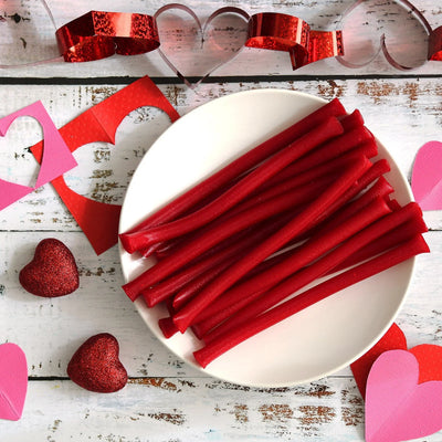 RED VINES Red Ropes Licorice on a white plate surrounded by valentine decor