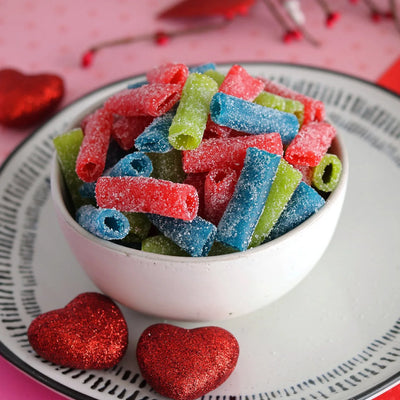 SOUR PUNCH Assorted Bites Candy in a white bowl surrounded by red sparkle hearts