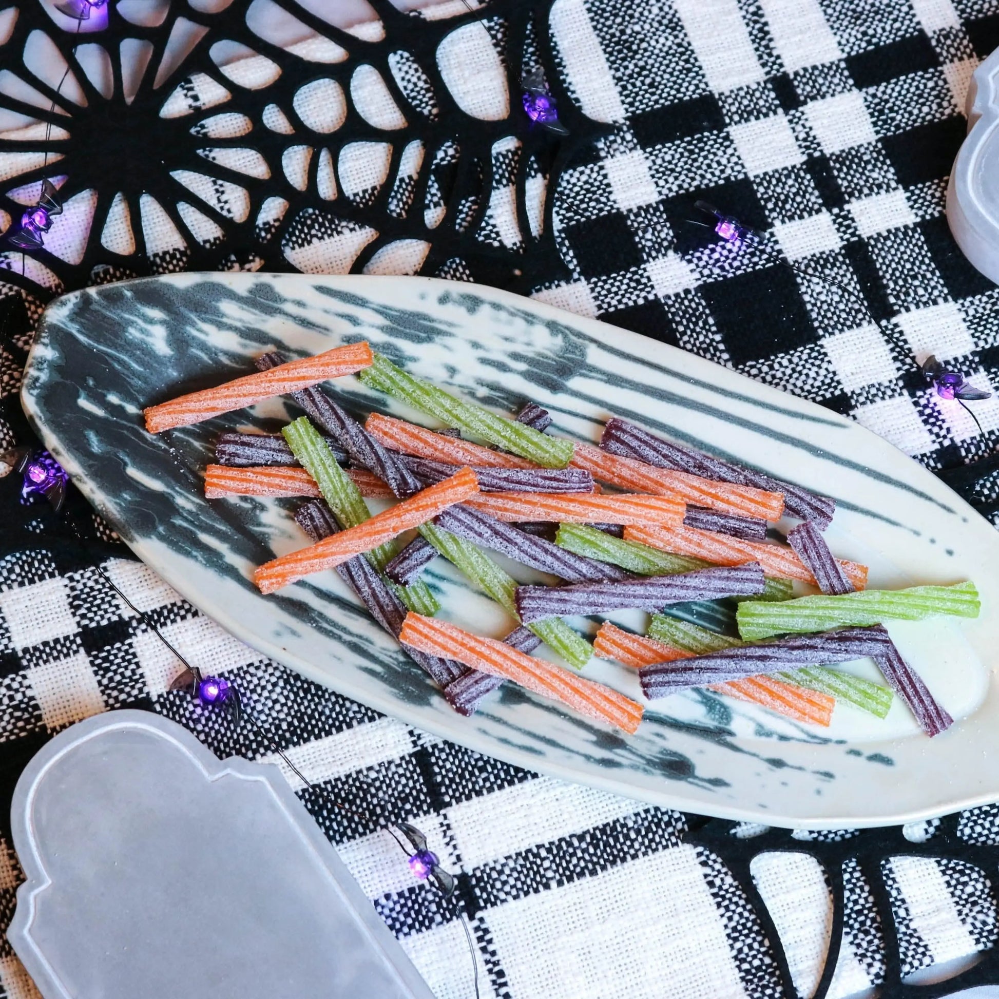 SOUR PUNCH Individually Wrapped Halloween Candy Twists on a spooky platter