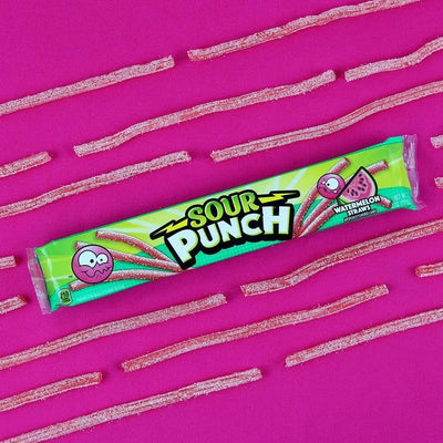 Sour Punch Watermelon Candy Straws 2oz Tray on a fuchsia background with raw candy straws arranged around the tray