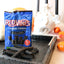 Red Vines Jumbo Black Licorice Candy on a black platter with pumpkins and fake skulls
