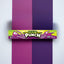 Sour Punch Grape Candy Straws 2oz Tray on a vertically split light purple and dark purple backgound