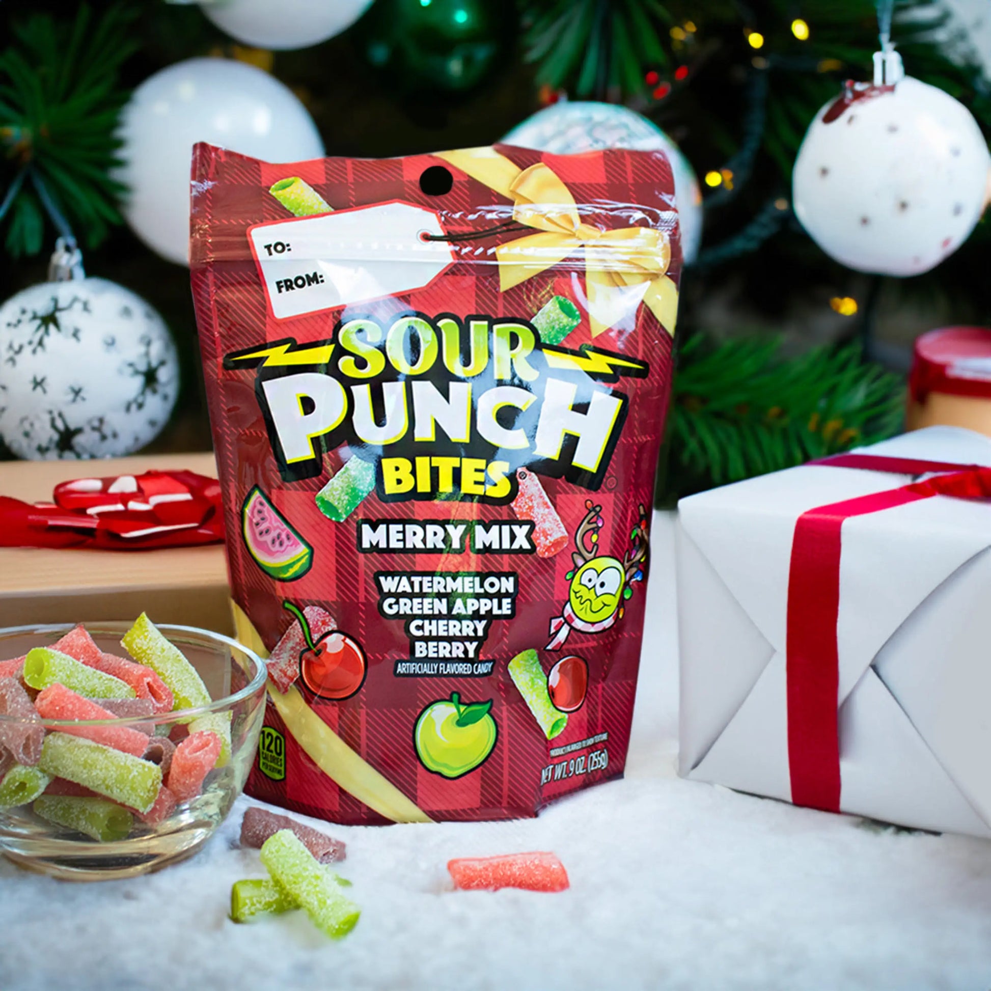 SOUR PUNCH Merry Mix Bites holiday candy next to gifts and decorated tree