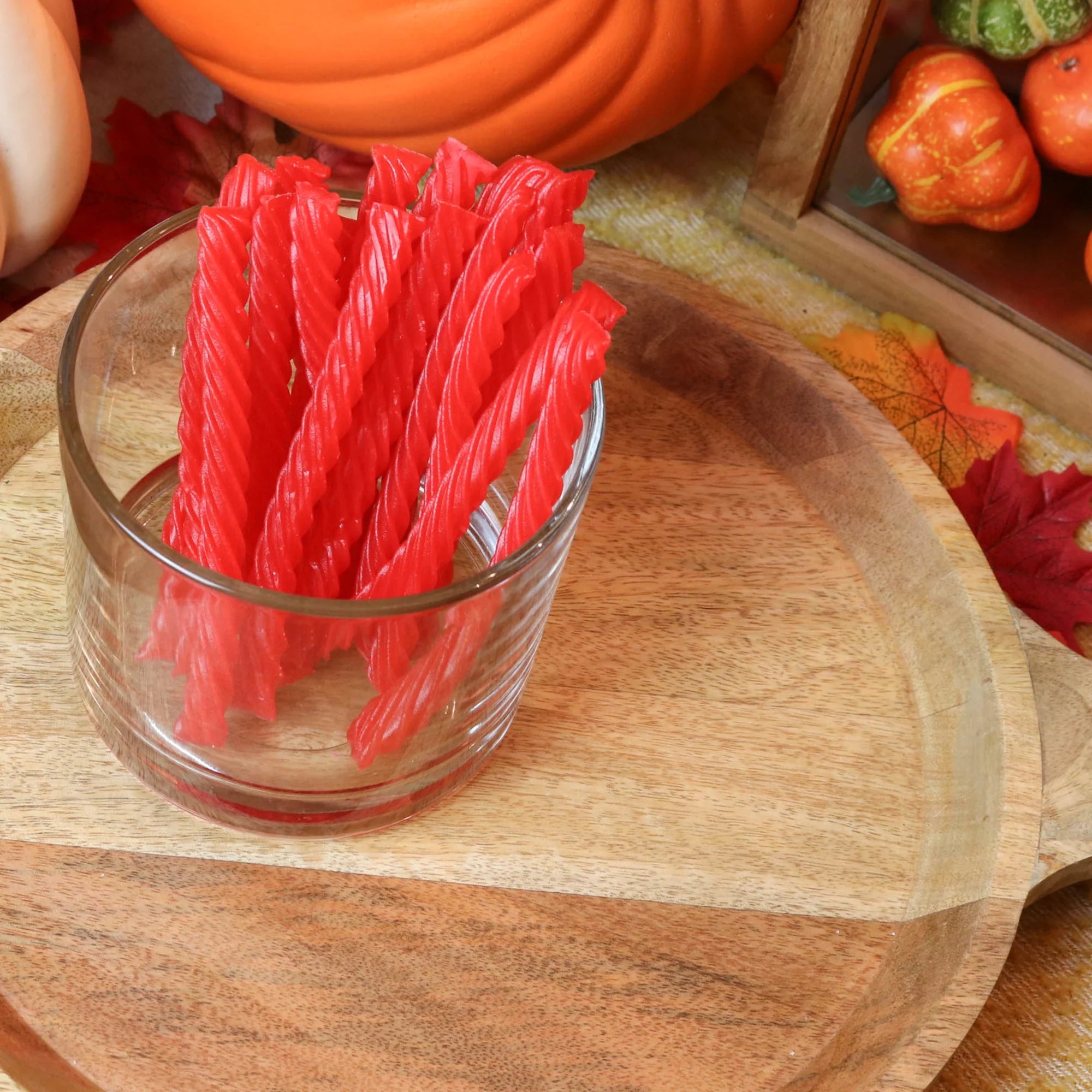 Red Vines Strawberry Sugar Free Licorice in a candy dish surrounded by pumpkins and leaves