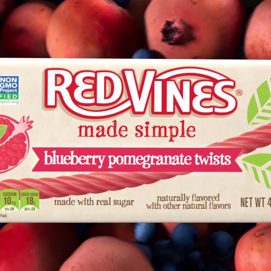 Animation of RED VINES Made Simple Blueberry Pomegranate Twists 4oz Tray coming out of a basket of fresh fruit