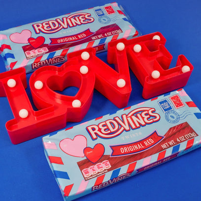 RED VINES Valentine's Day Licorice Candy Twists on a blue background with a 
