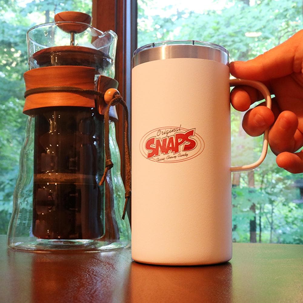 Relaxing and looking out a window with a SNAPS Travel Mug
